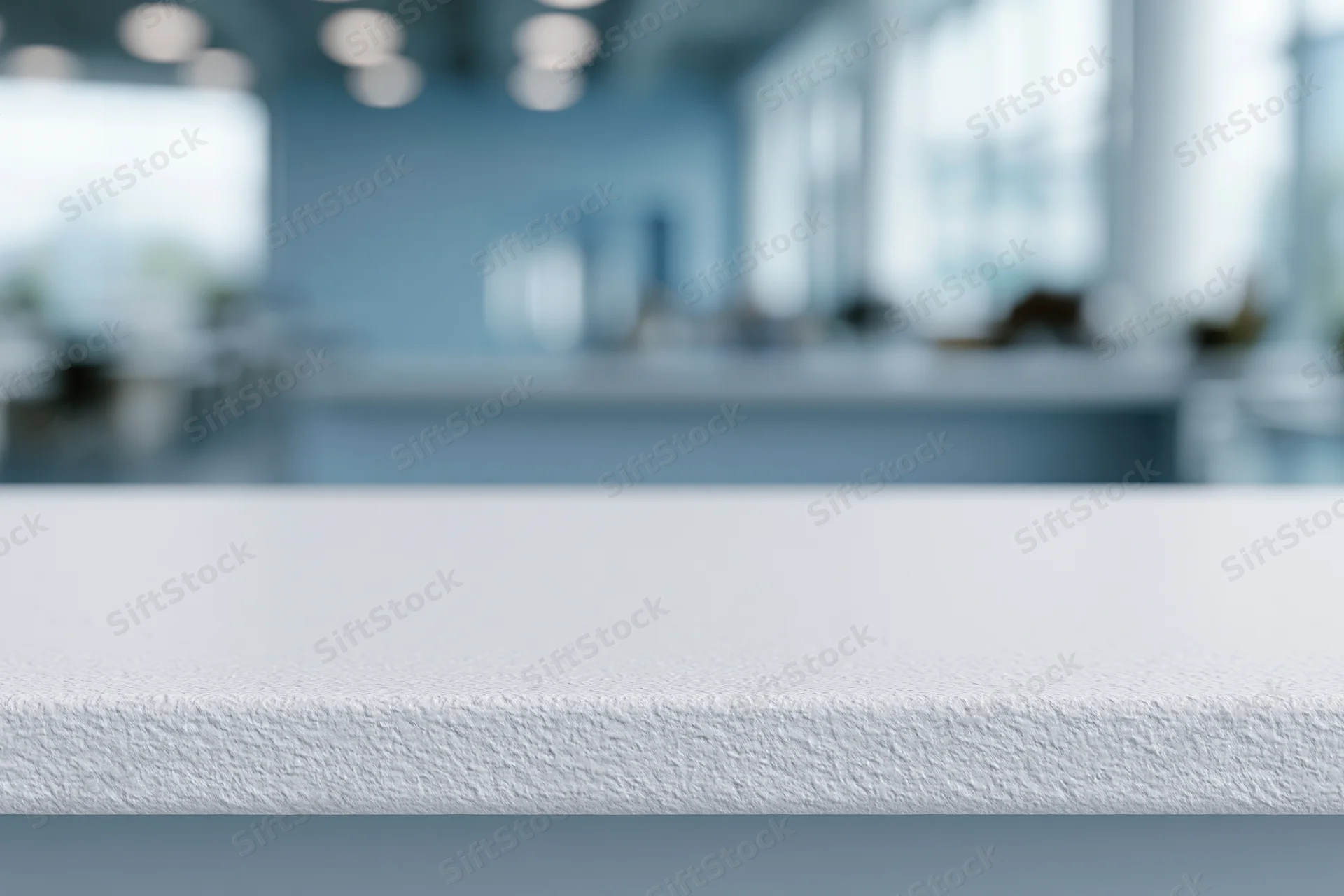 White textured tabletop surface in foreground with blurred office interior background
