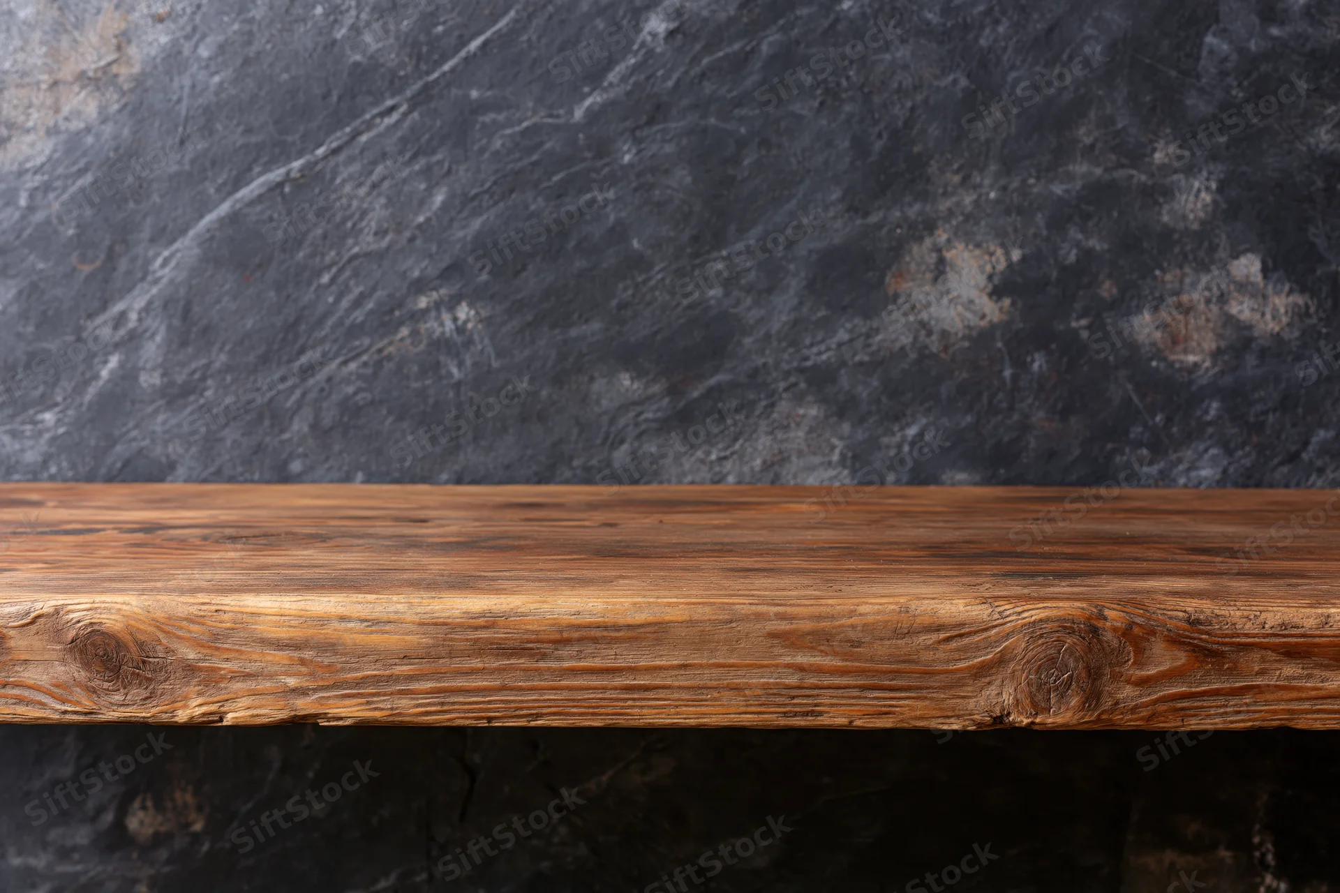 Empty rustic wooden shelf mounted on dark stone wall with copyspace for display