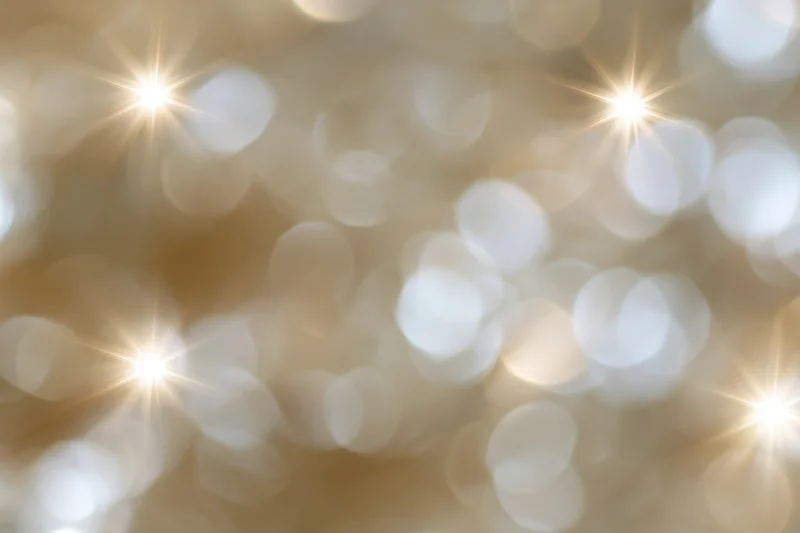 Abstract bokeh background of out-of-focus holiday lights with golden sparkles and soft glow
