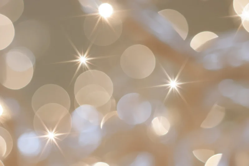 Abstract bokeh lights in warm golden tones forming a festive holiday background