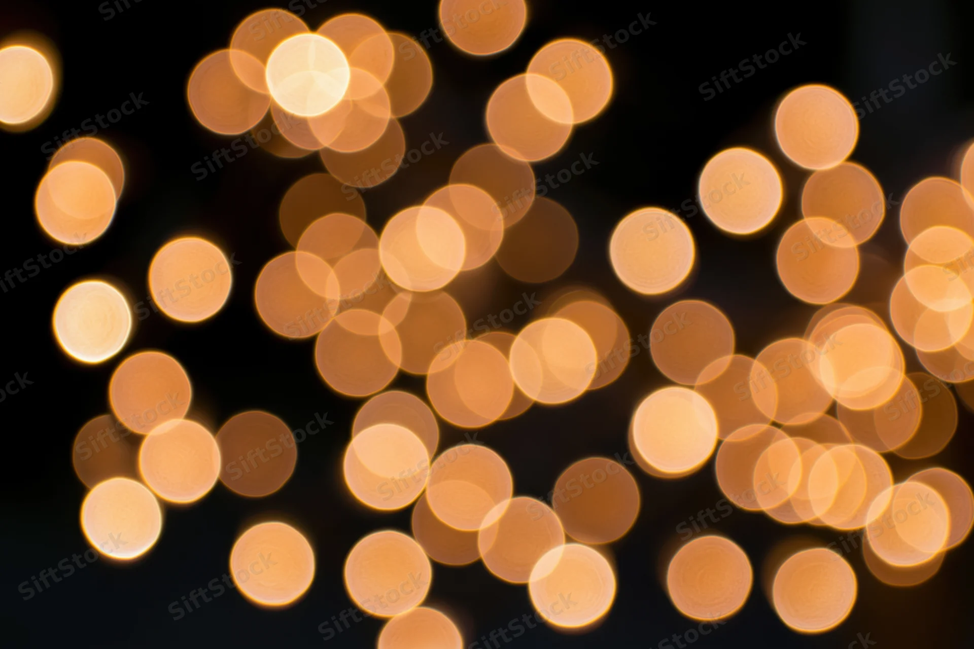 Out-of-focus string lights creating warm circular bokeh against dark background