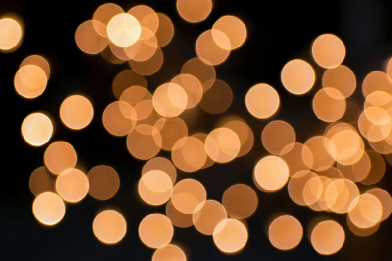 Out-of-focus string lights creating warm circular bokeh against dark background