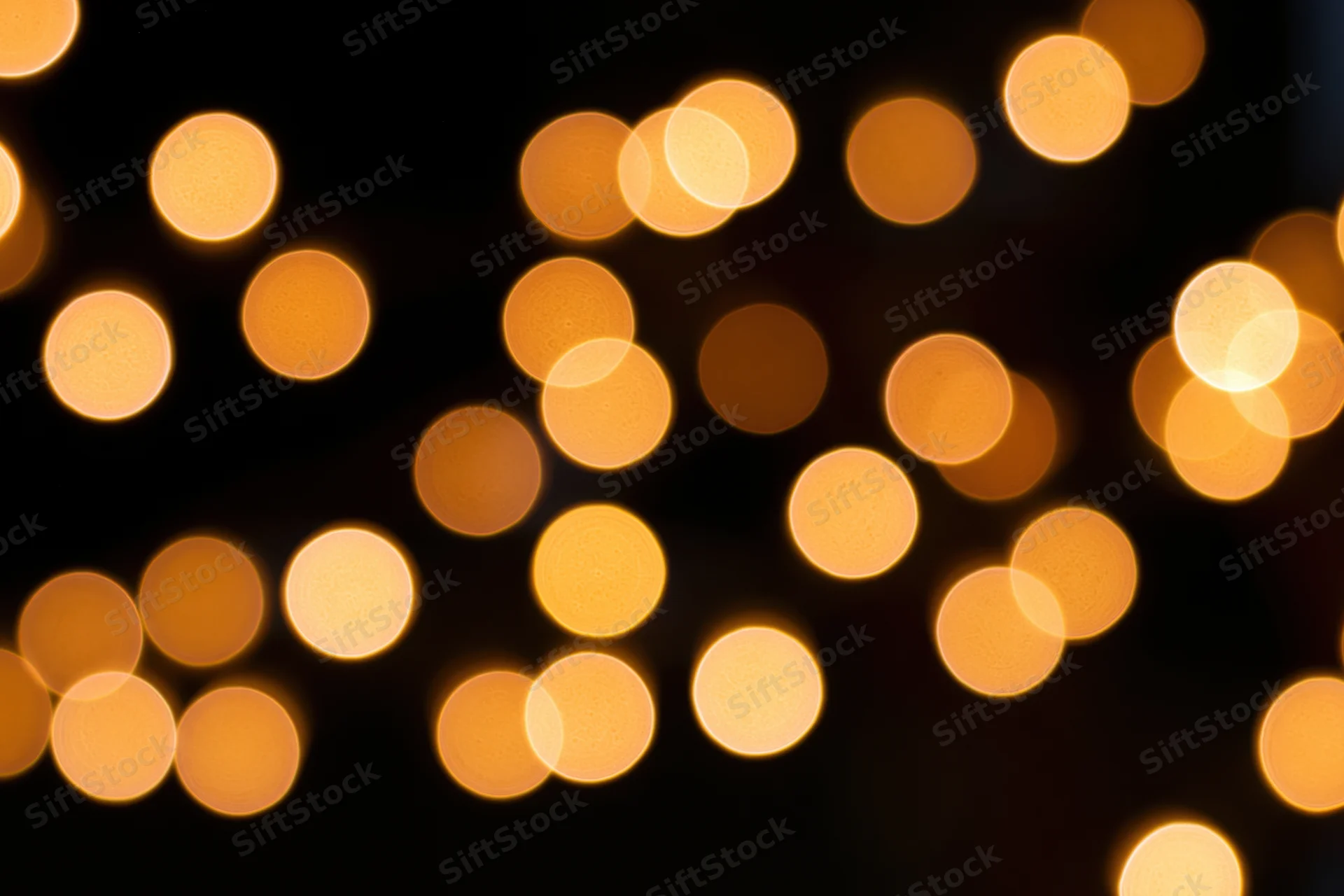 Out-of-focus string lights creating warm circular bokeh against dark background