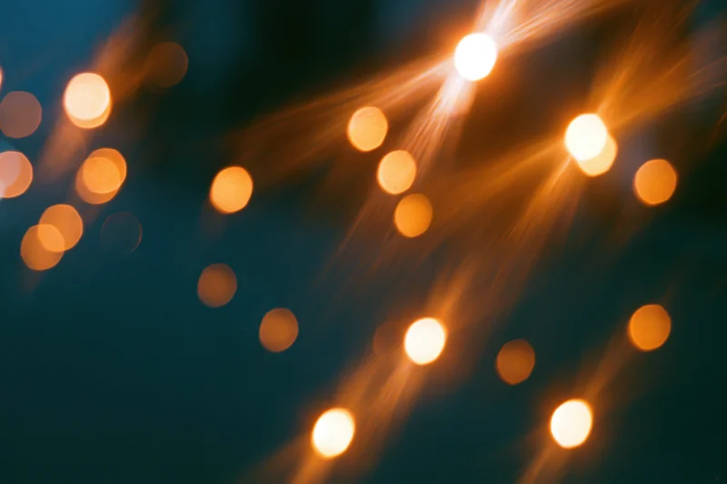 Warm out-of-focus lights arranged in a scattered pattern against a dark background