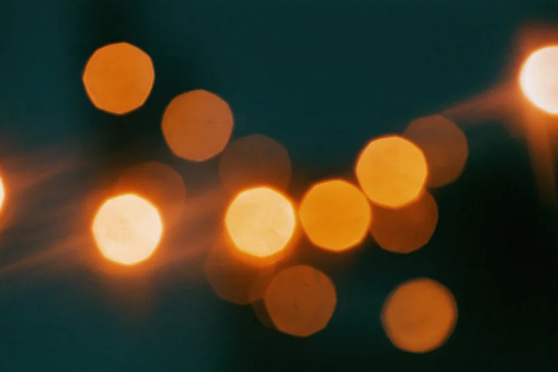 Warm out-of-focus lights arranged in a scattered pattern against a dark background