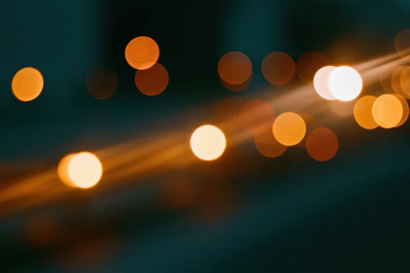 Warm out-of-focus lights in a blurred urban night scene with light streaks and bokeh circles