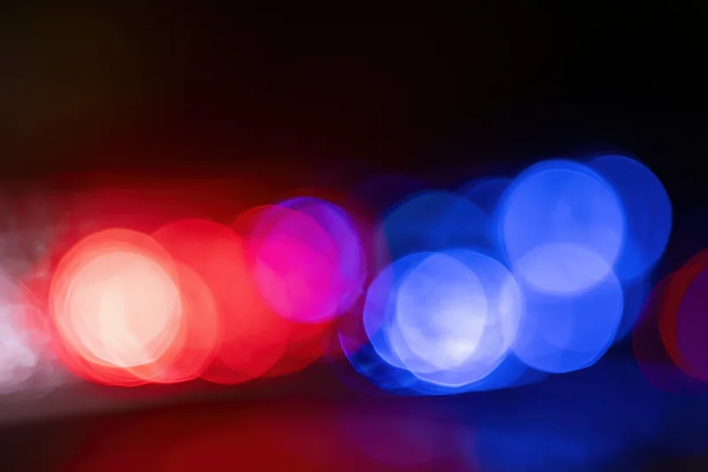 Blurred bokeh of red and blue police emergency lights at night