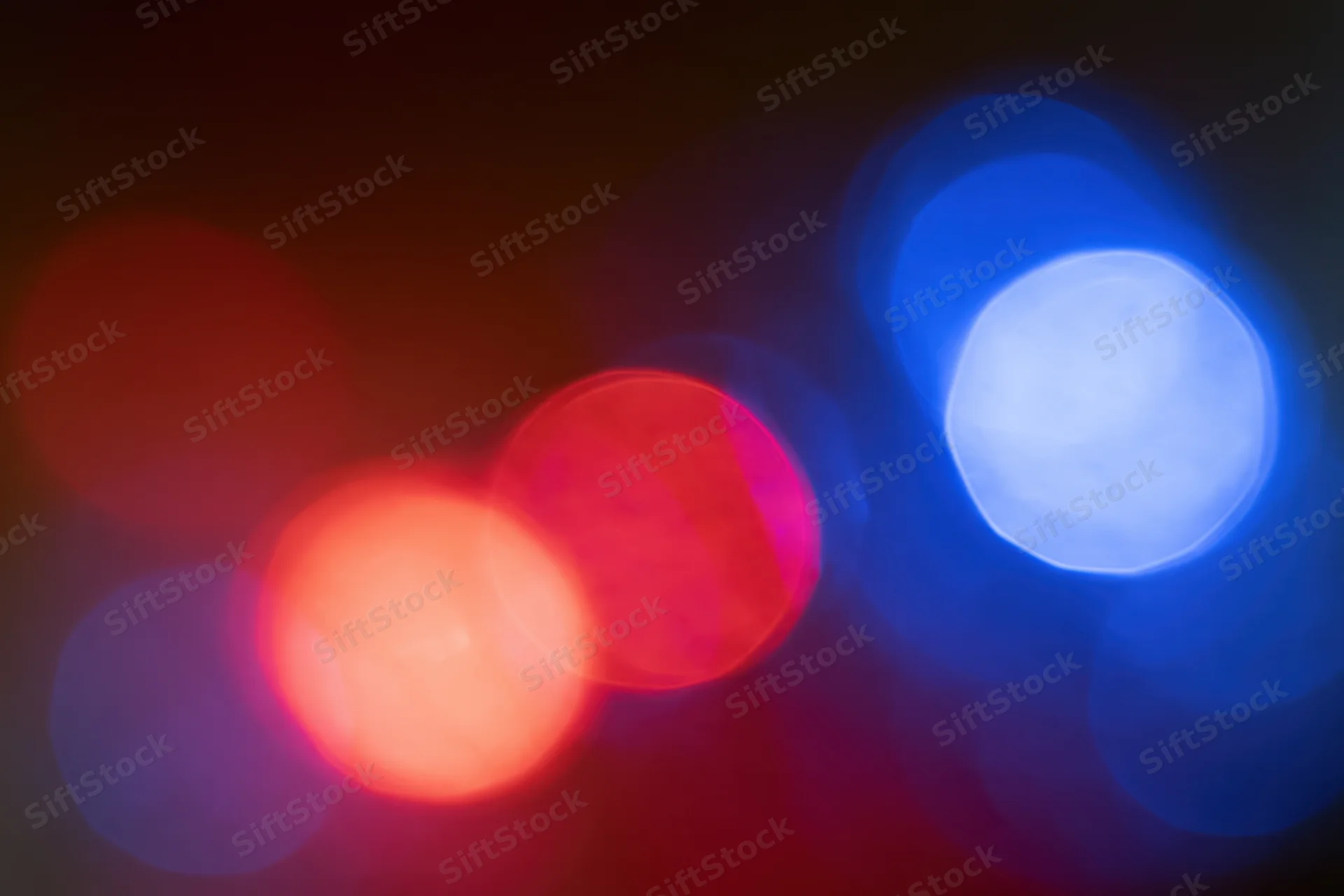Blurred red and blue emergency lights at night