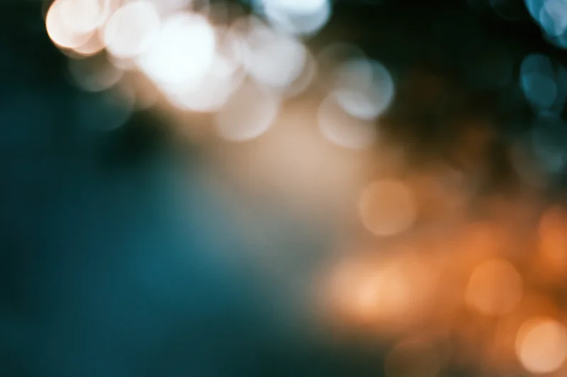Blurred bokeh lights in warm and cool tones forming an abstract background