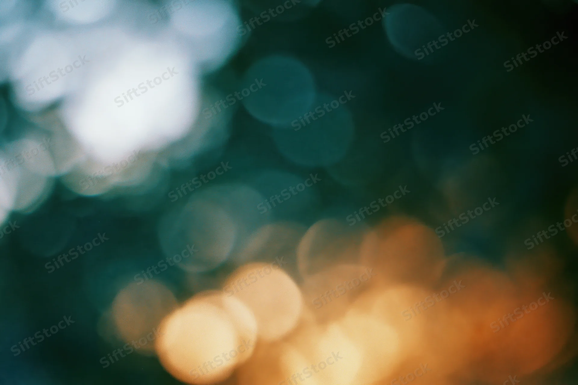Blurred circular lights in warm and cool tones against a dark background