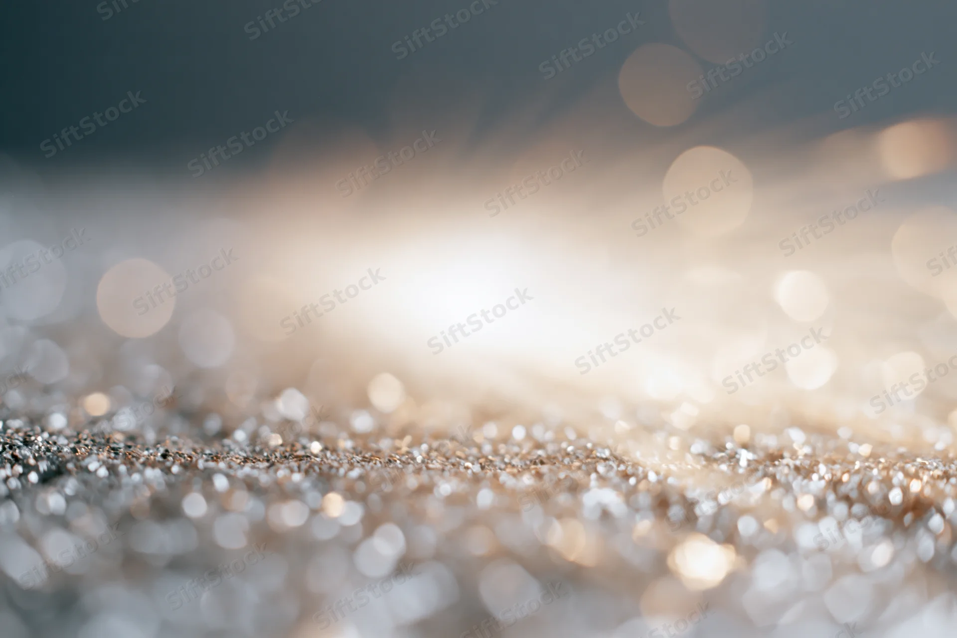 Glittering surface with sparkling bokeh lights in soft focus, creating a festive abstract background