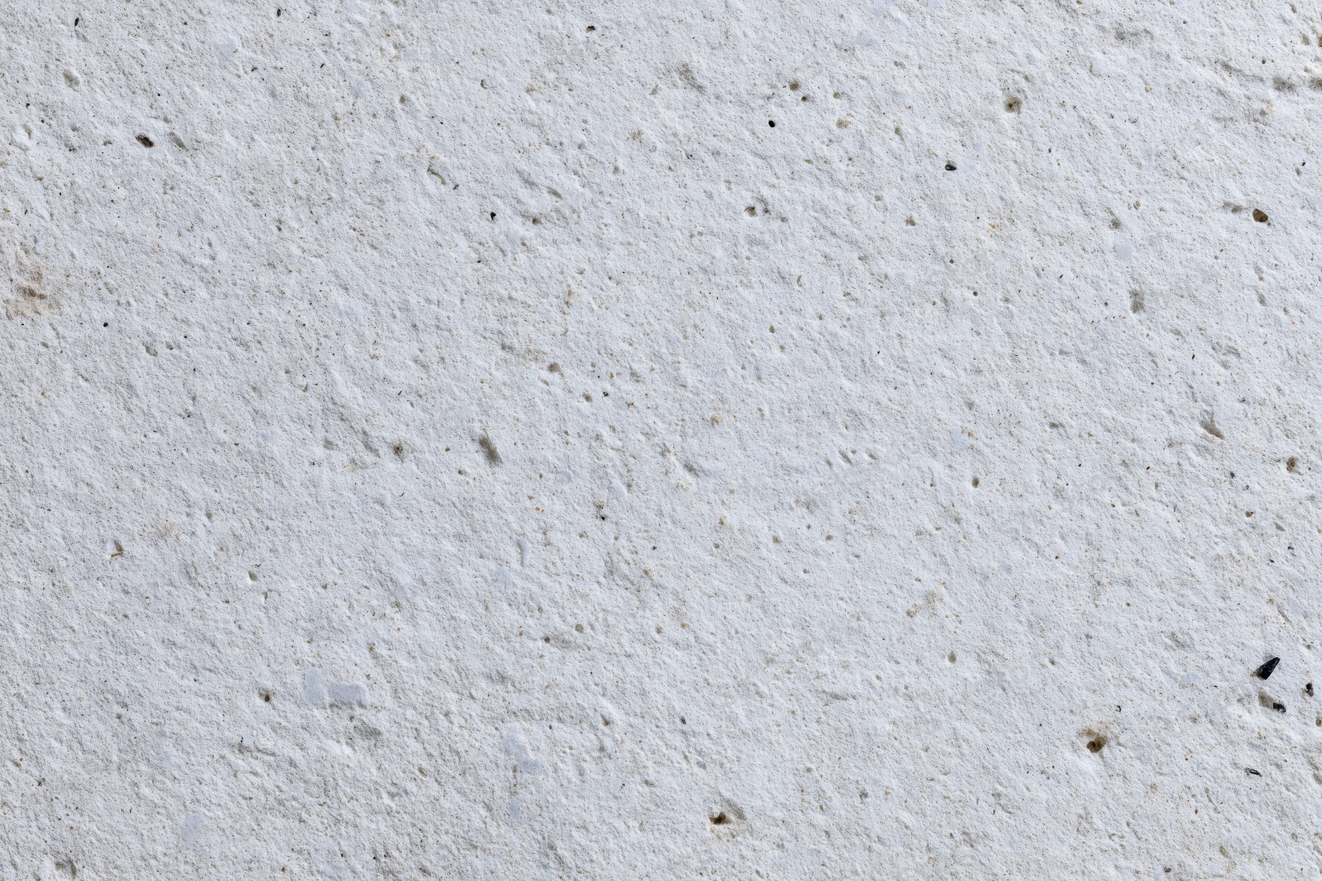 Flat concrete wall surface filling the frame with rough texture and small imperfections