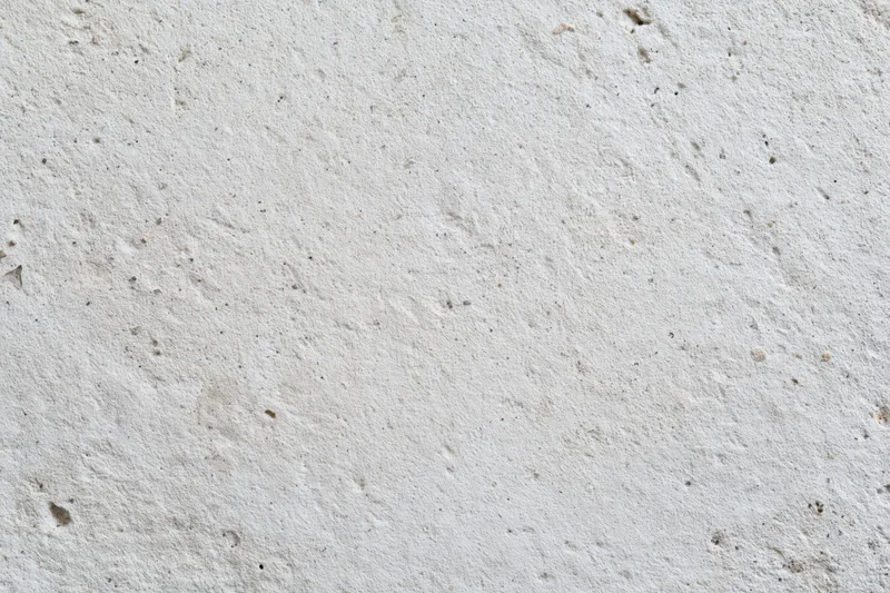 Flat concrete wall surface filling the frame with rough texture and small imperfections