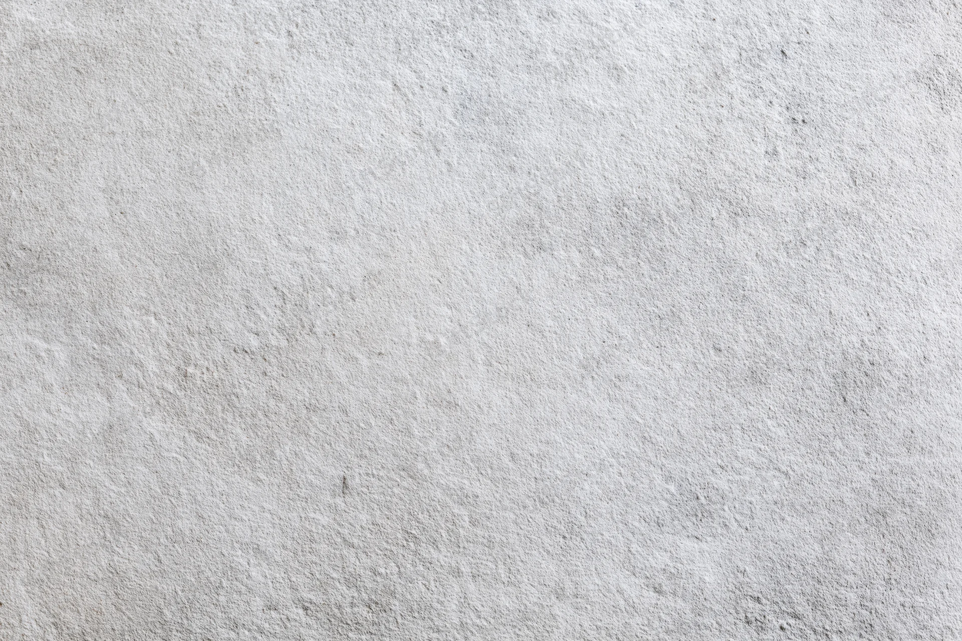 Flat concrete wall surface filling the frame with rough texture and gray tone
