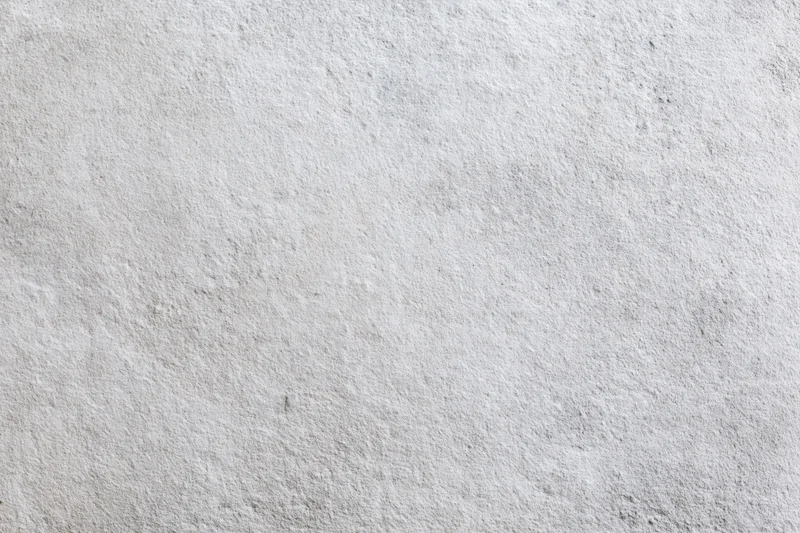 Flat concrete wall surface filling the frame with rough texture and gray tone