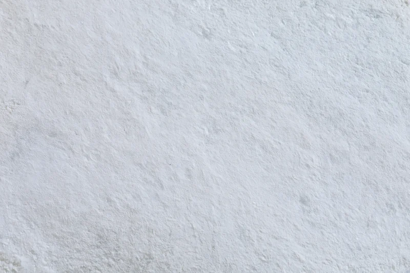 Flat concrete wall surface filling the frame with rough texture and gray tone