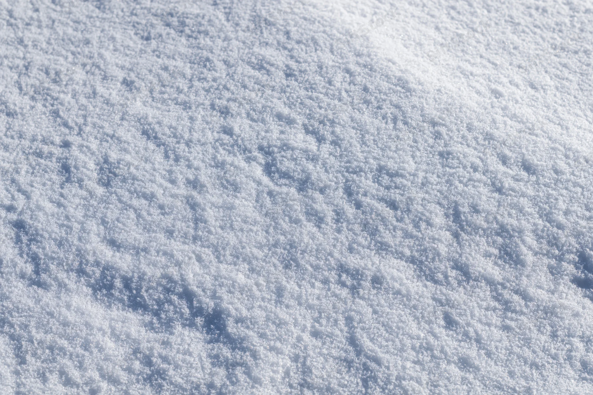 Flat expanse of fresh undisturbed snow covering the ground