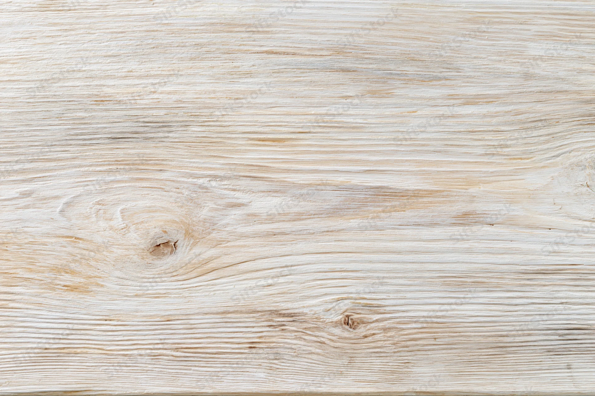 Whitewashed wooden board surface with visible grain and knots in flat lay closeup
