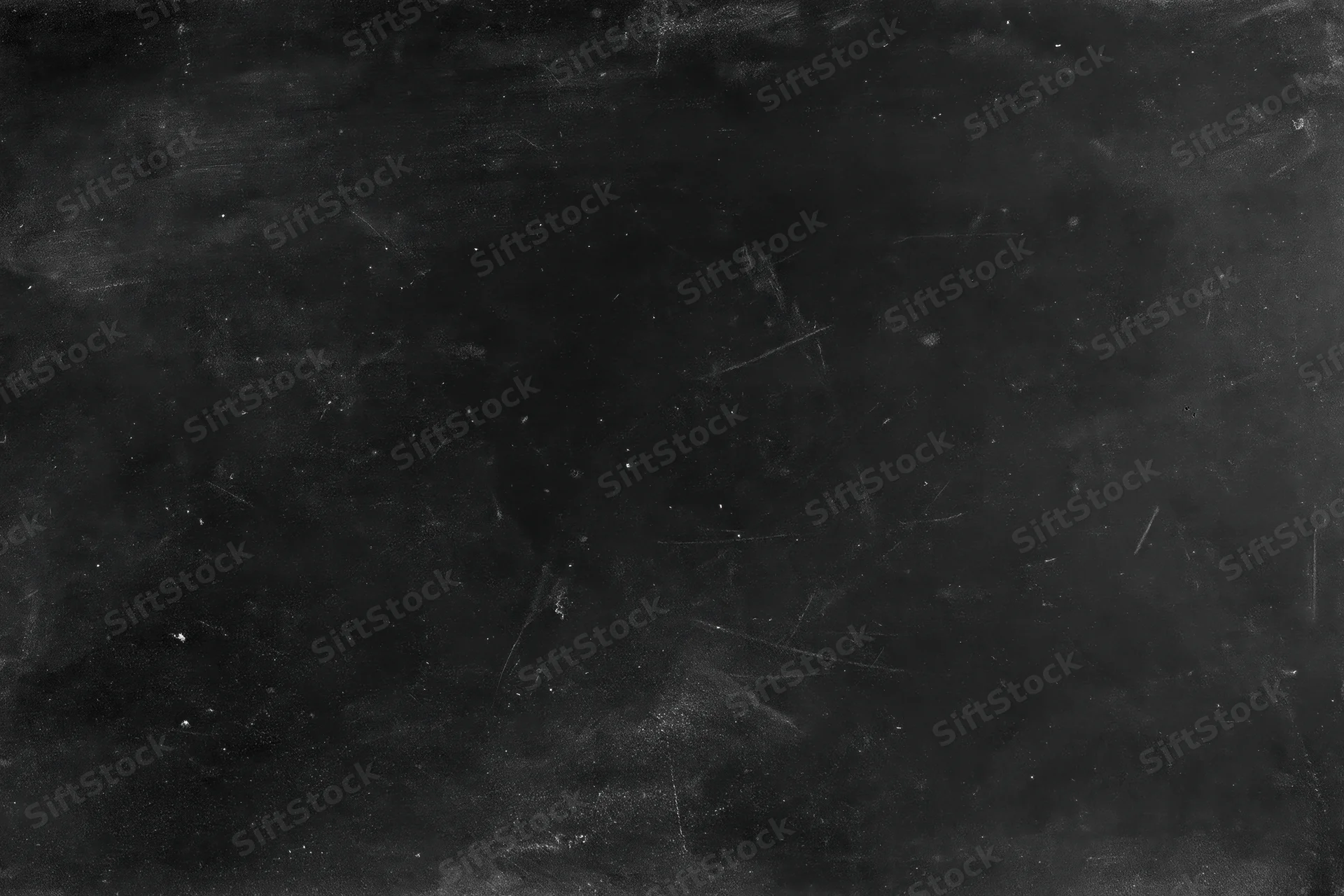 Worn black chalkboard surface with scratches and chalk residue in flat lay closeup