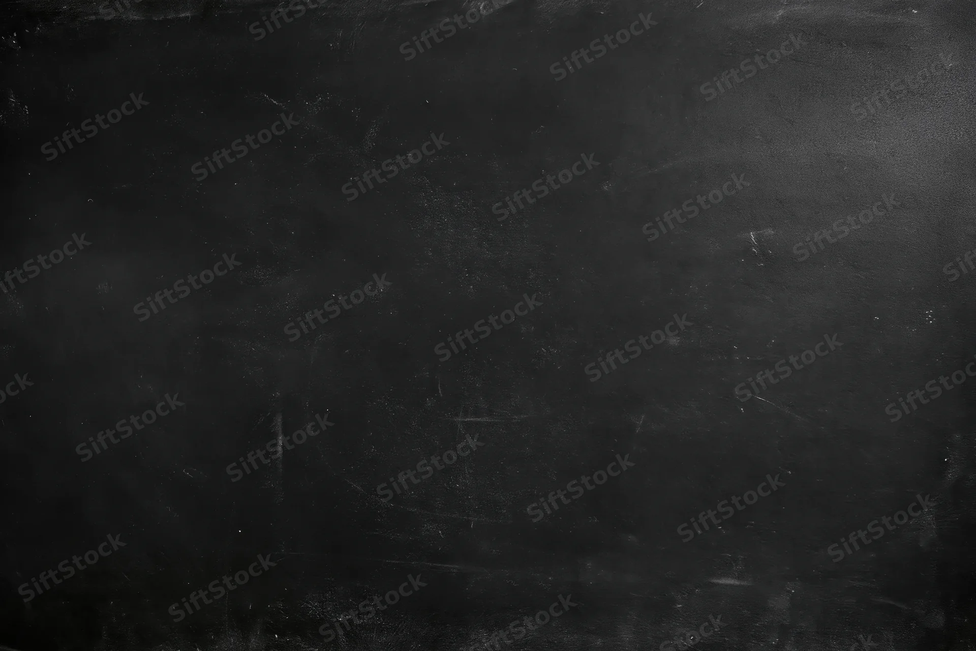 Worn black chalkboard surface with smudges and scratches in flat lay closeup
