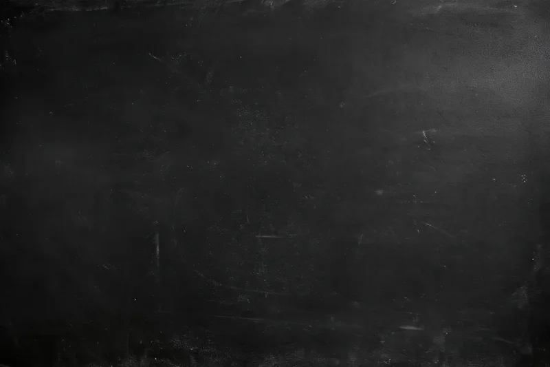 Worn black chalkboard surface with smudges and scratches in flat lay closeup