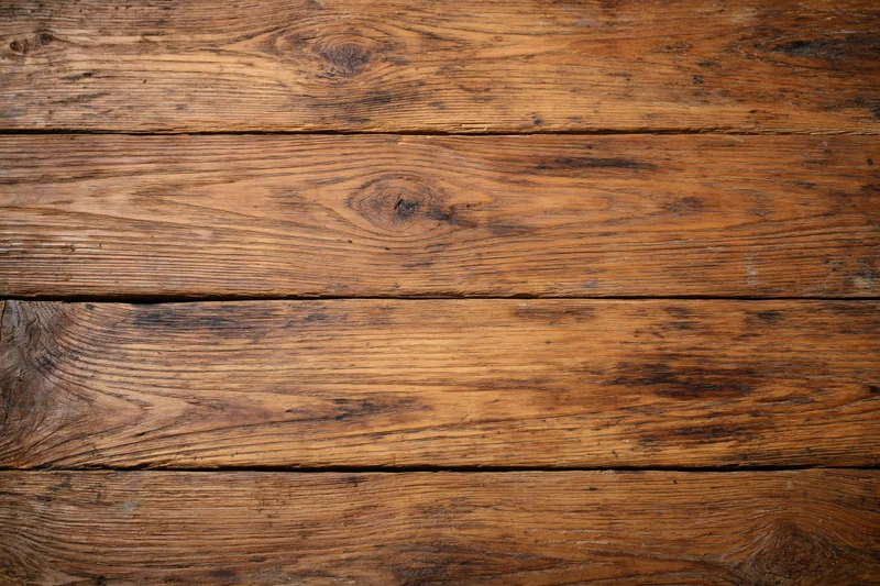 Aged horizontal wooden planks arranged in a flat lay filling the frame