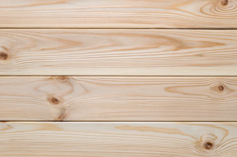 Horizontal light pine wood planks arranged in a flat lay surface view