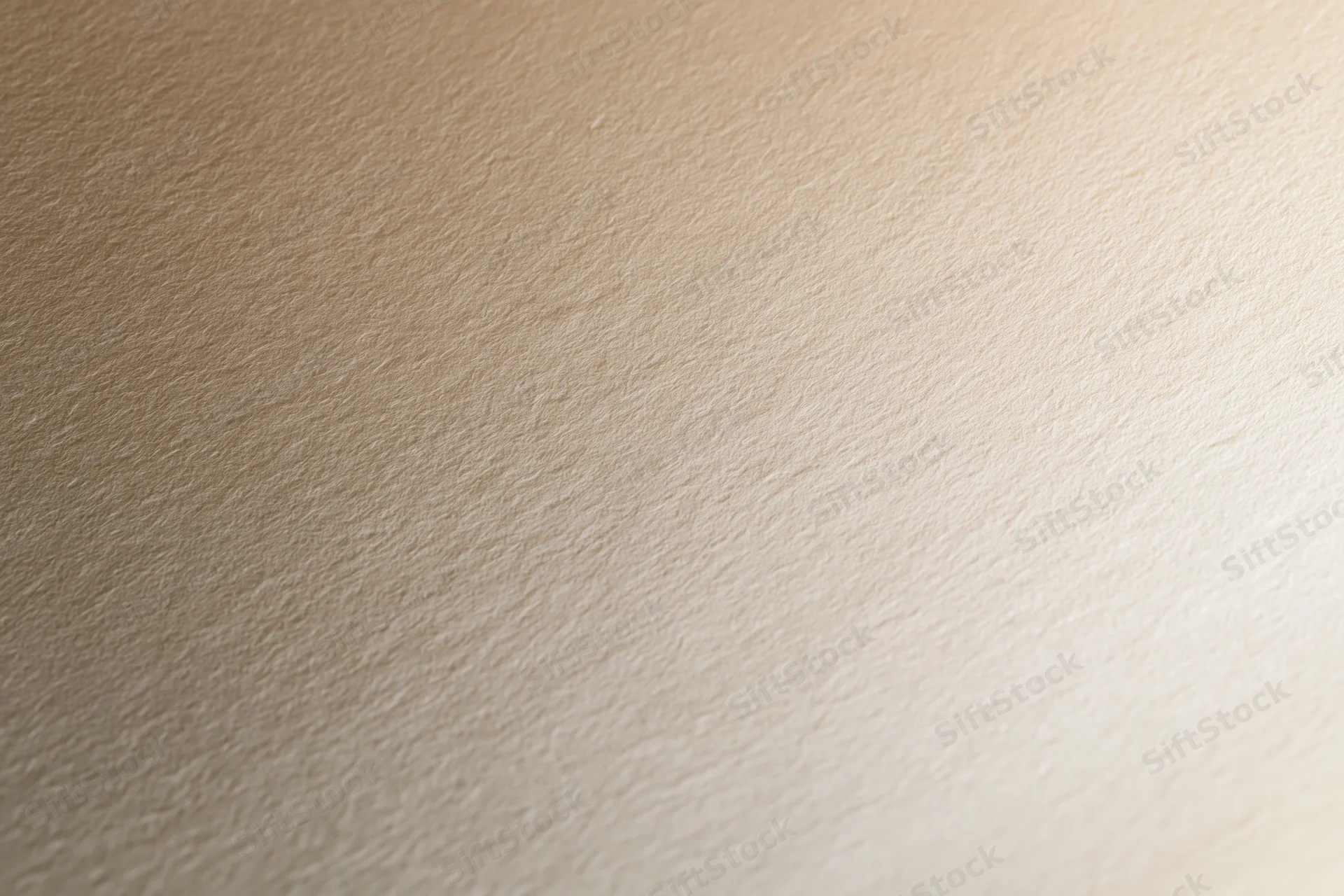 Close-up of smooth cream-colored paper surface with subtle texture and even lighting