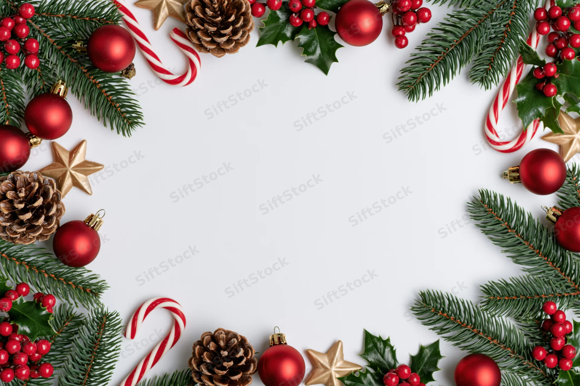 Christmas decorations arranged as a border frame on white background with copyspace
