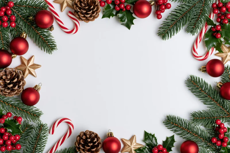 Christmas decorations arranged as a border frame on white background with copyspace