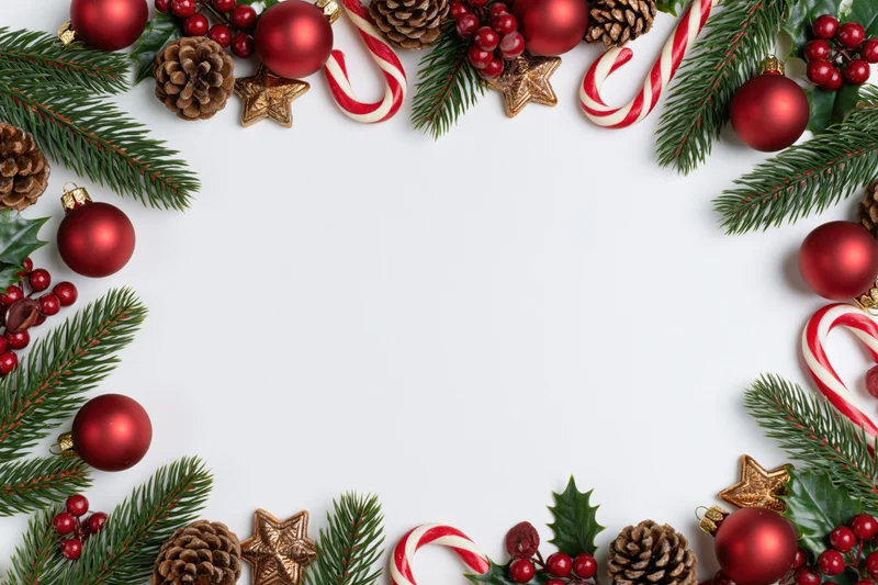 Christmas decorations arranged as a border frame on white background with copyspace