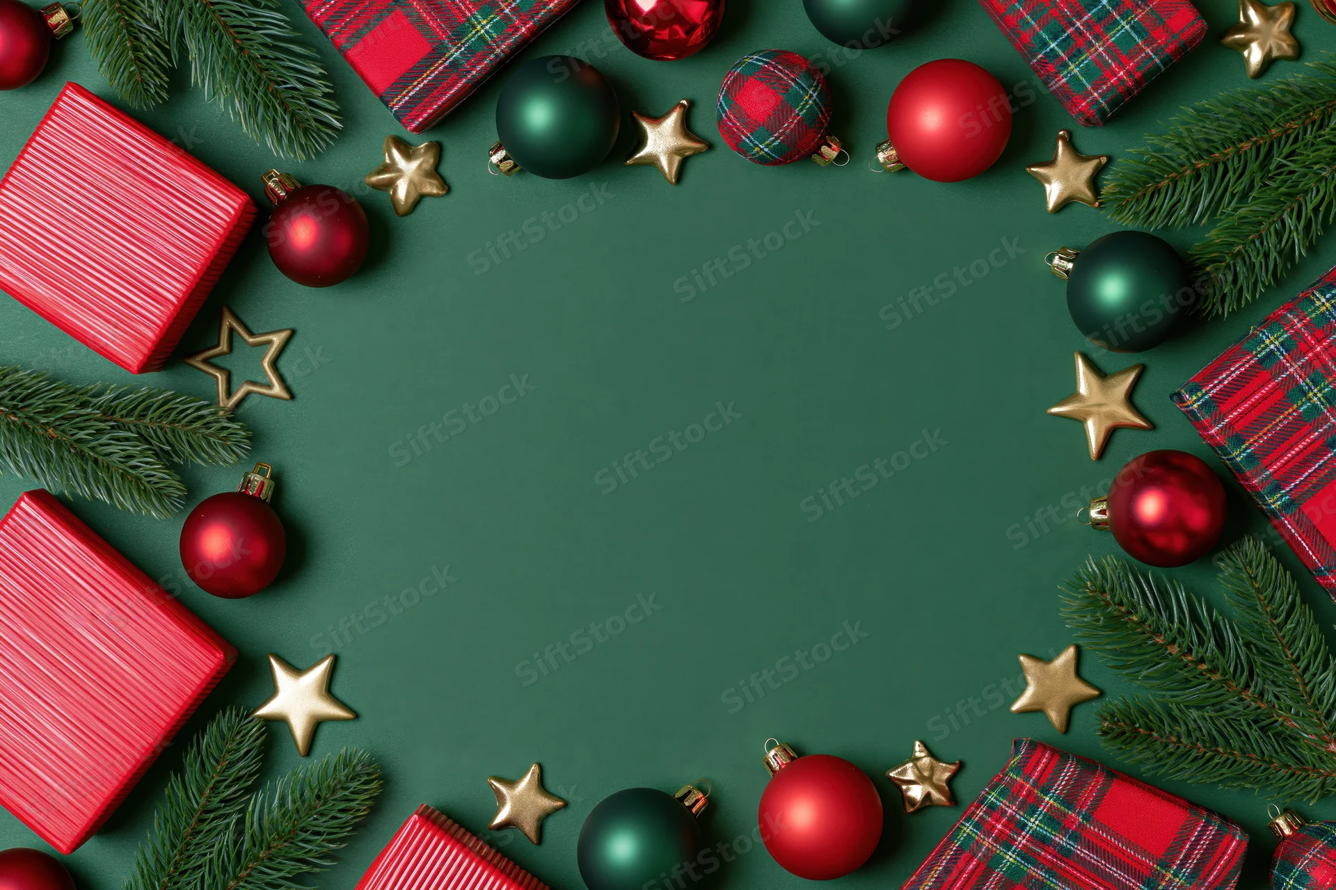 Christmas ornaments and wrapped gifts arranged in a flat lay with pine branches and gold stars on a green background