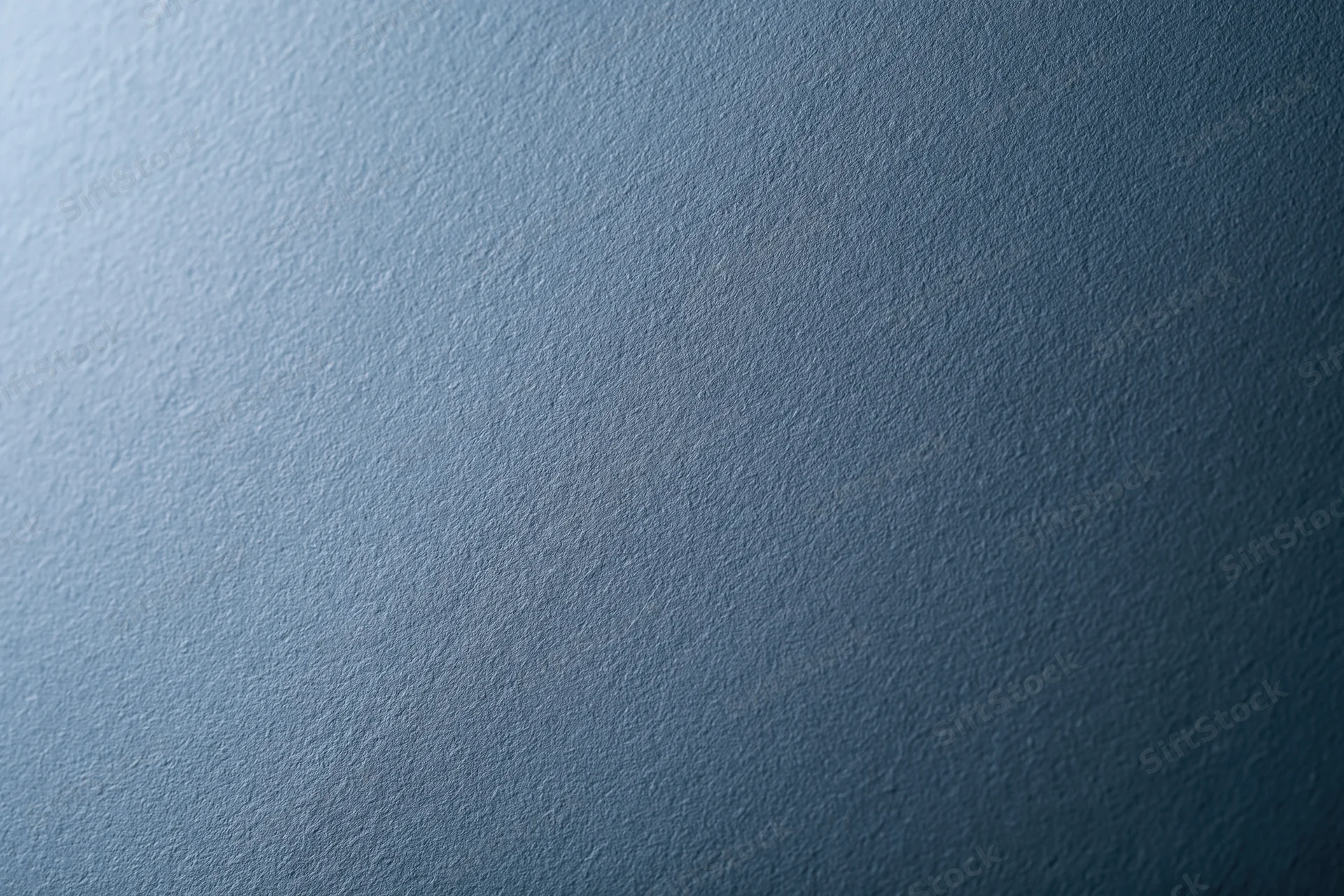 Flat matte steel-blue textured surface filling the frame