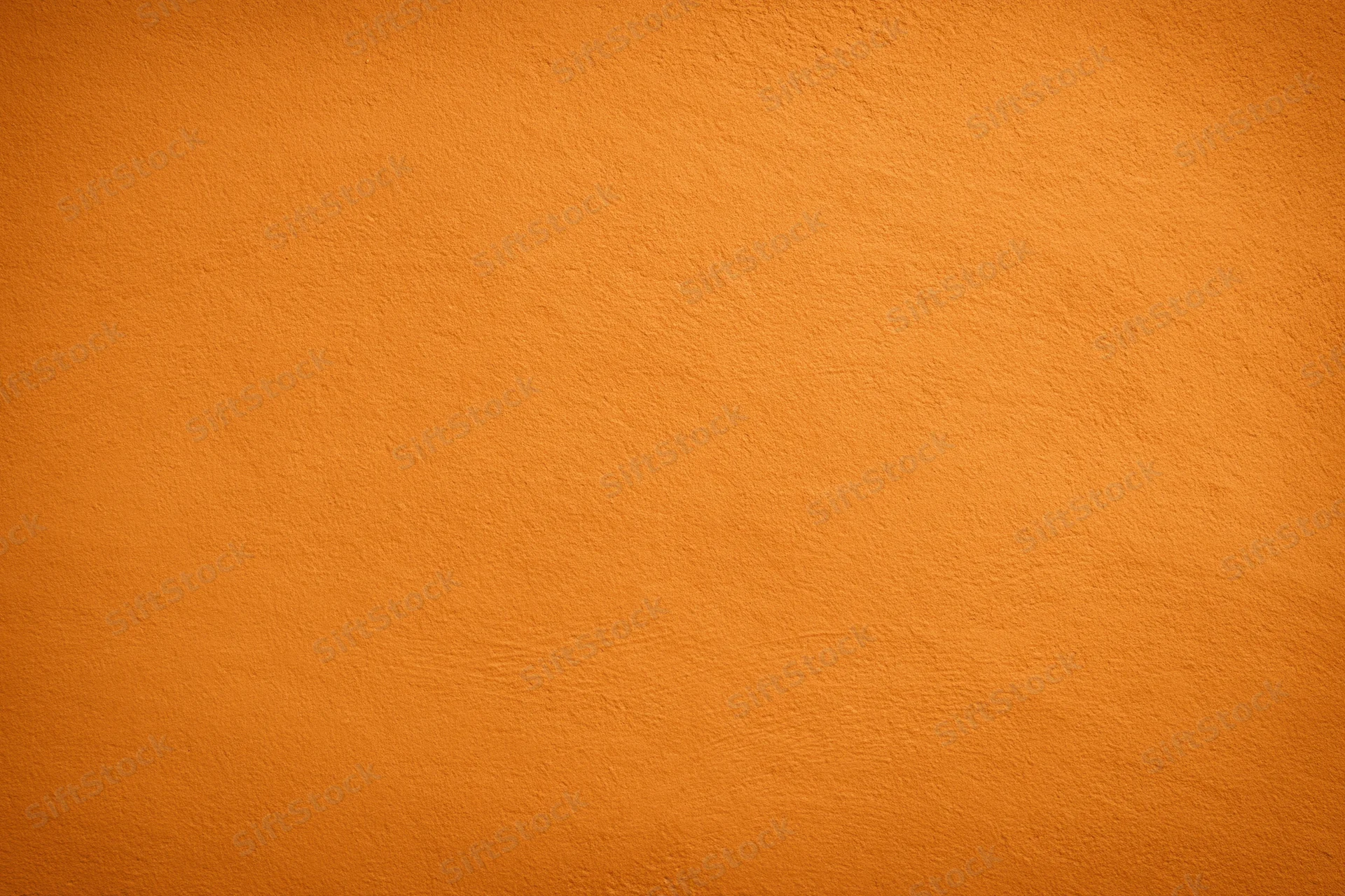 Orange painted wall surface filling the frame as a seamless background