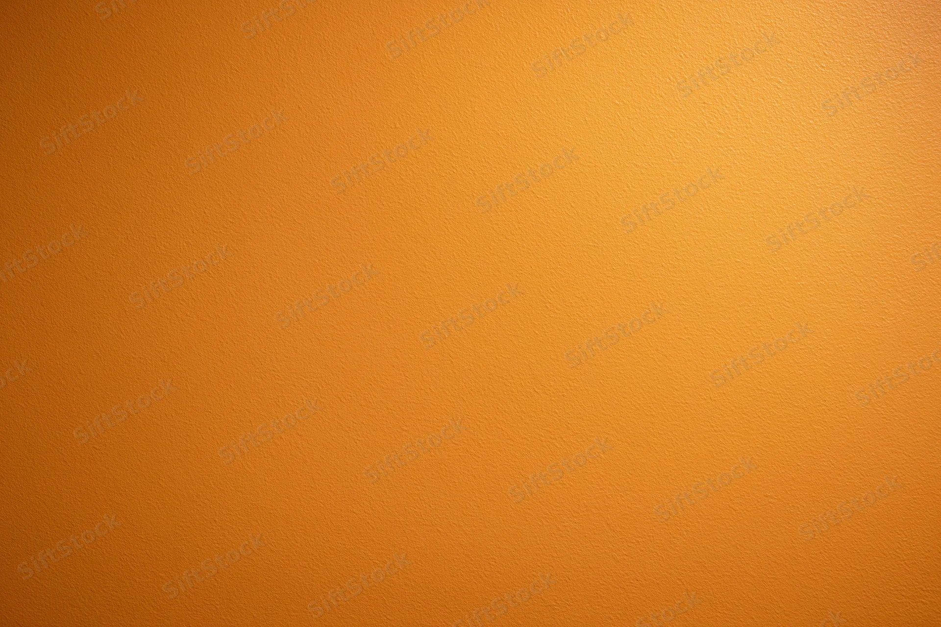 Orange painted wall surface filling the frame as a seamless background