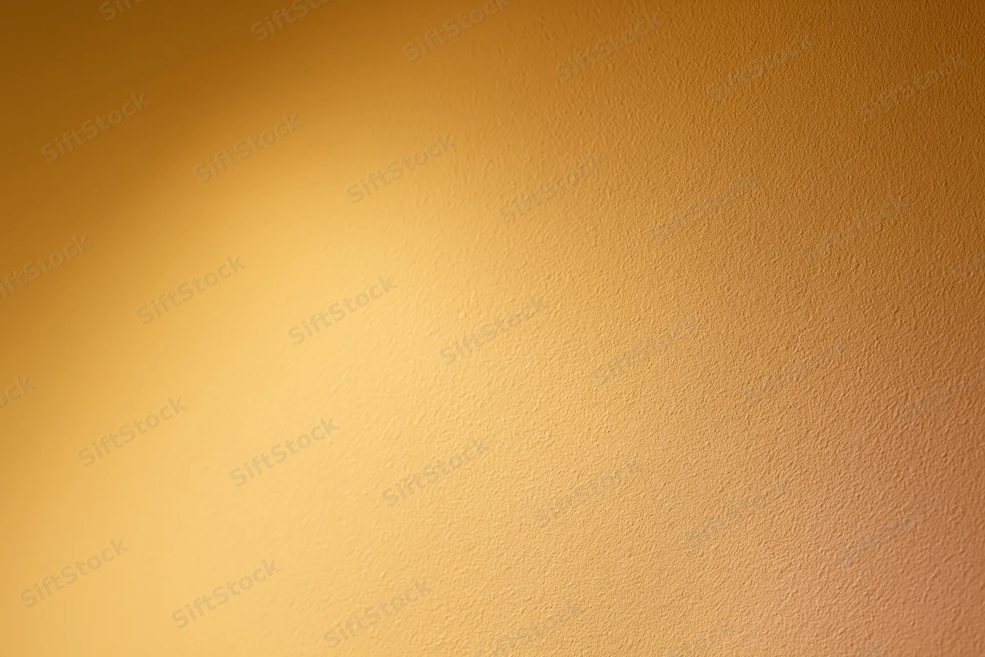 Flat painted wall surface filling the frame with smooth matte finish and warm gradient tone