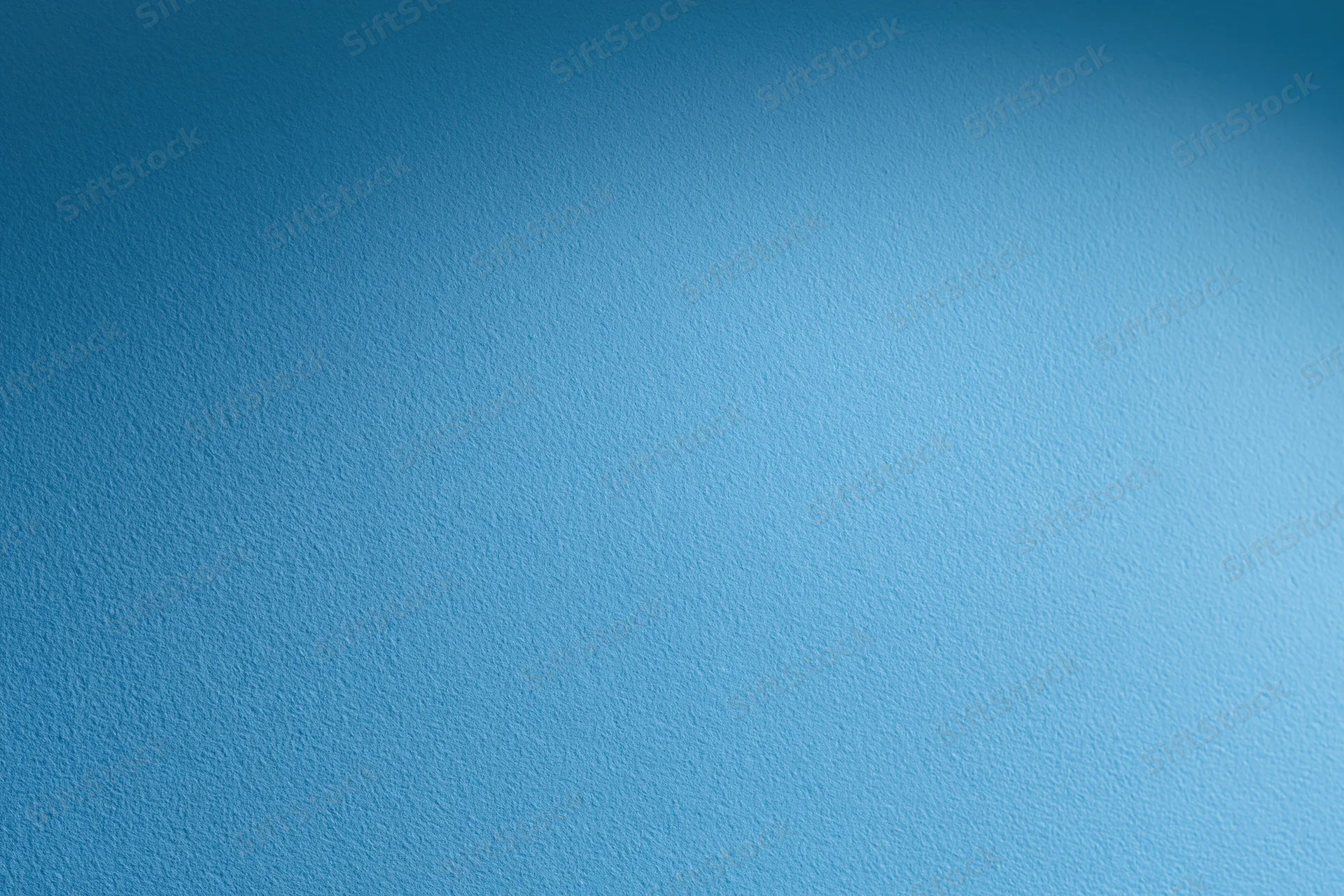 Solid blue painted wall surface filling the frame as a background