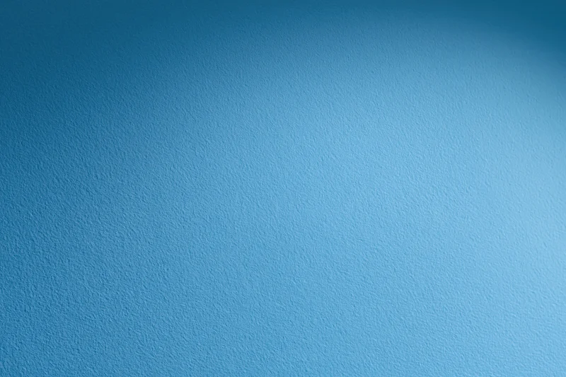 Solid blue painted wall surface filling the frame as a background