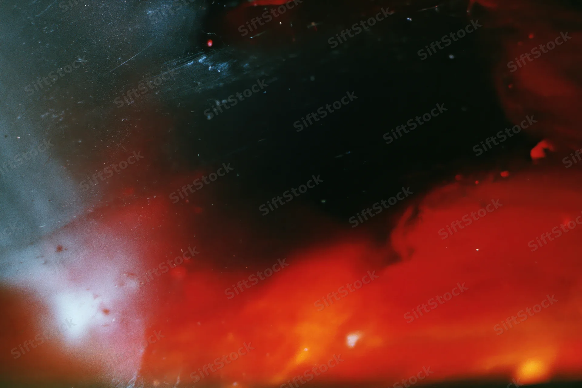 Abstract analog photograph with heavy light leaks and underexposure showing red and black color fields