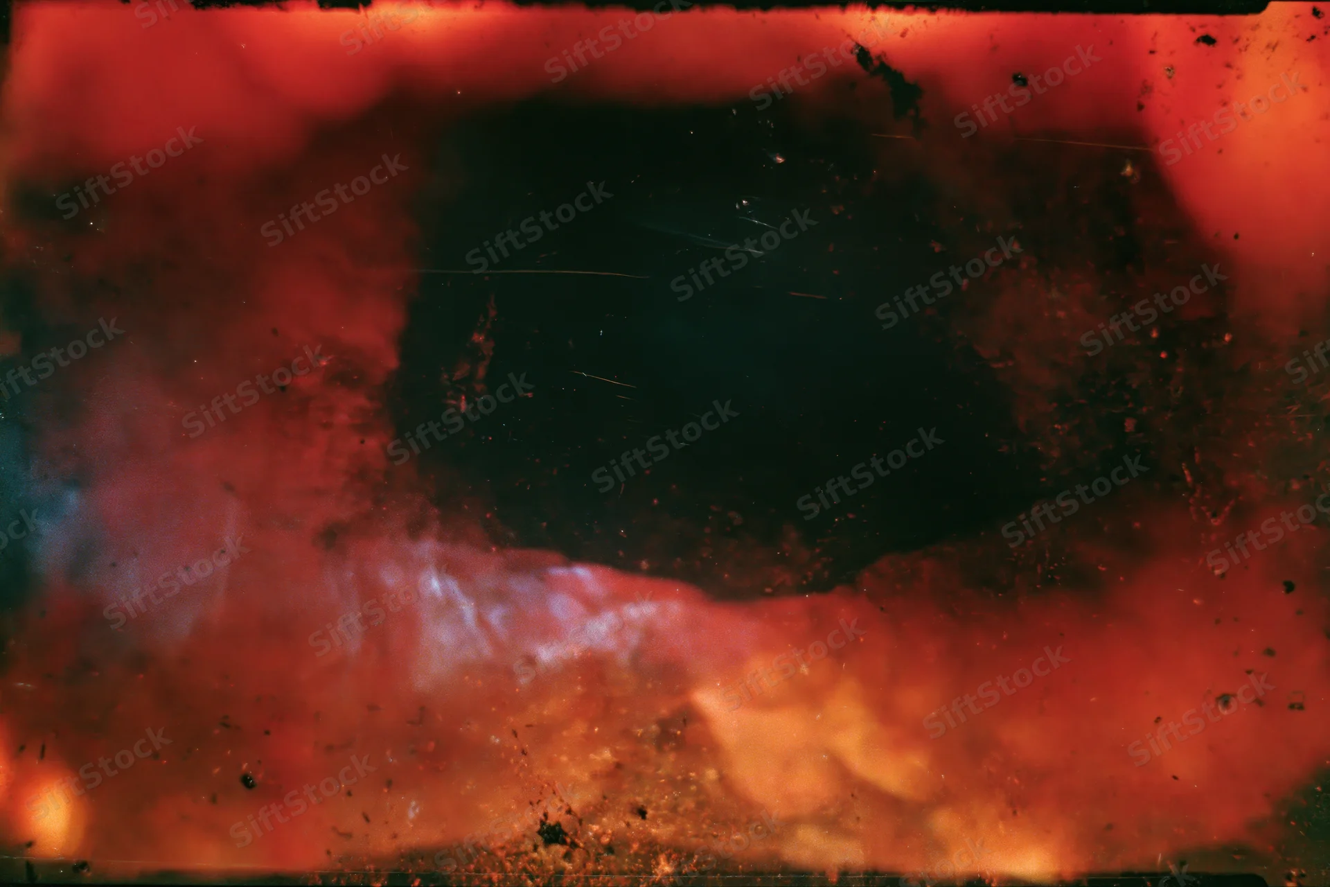 Abstract analog photograph with heavy light leak and underexposure, featuring red and black tones and a central dark void