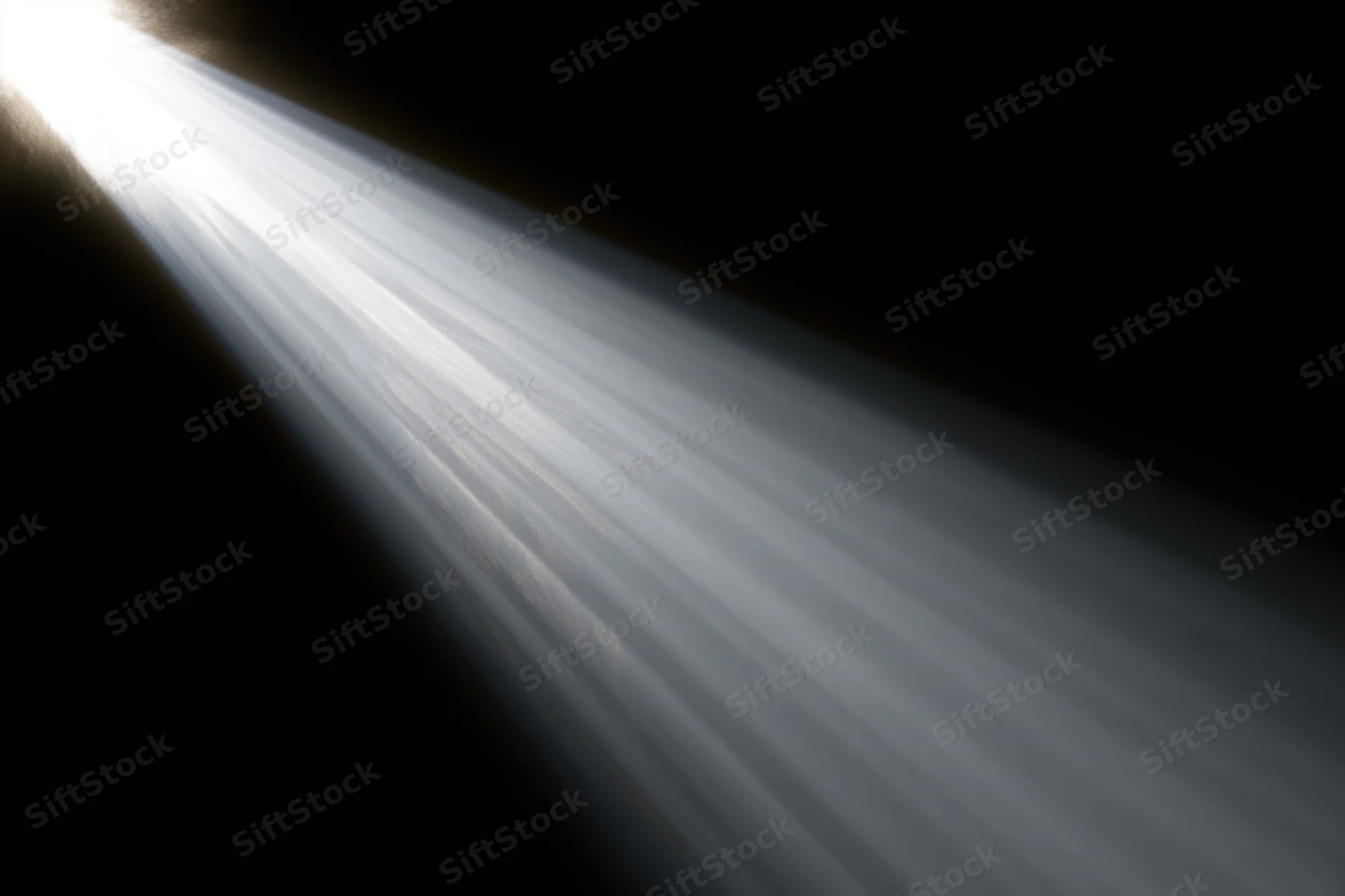 Intense white light rays radiating diagonally from upper left across dark background