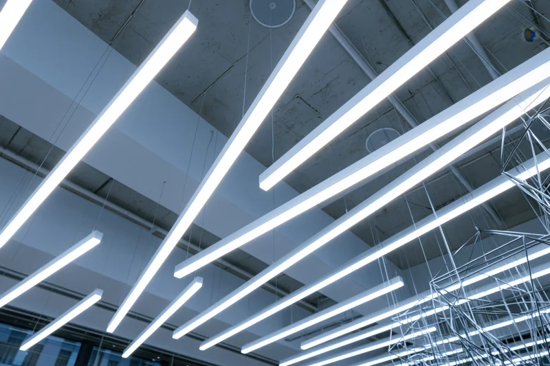 Modern ceiling with suspended fluorescent light tubes in a public building interior