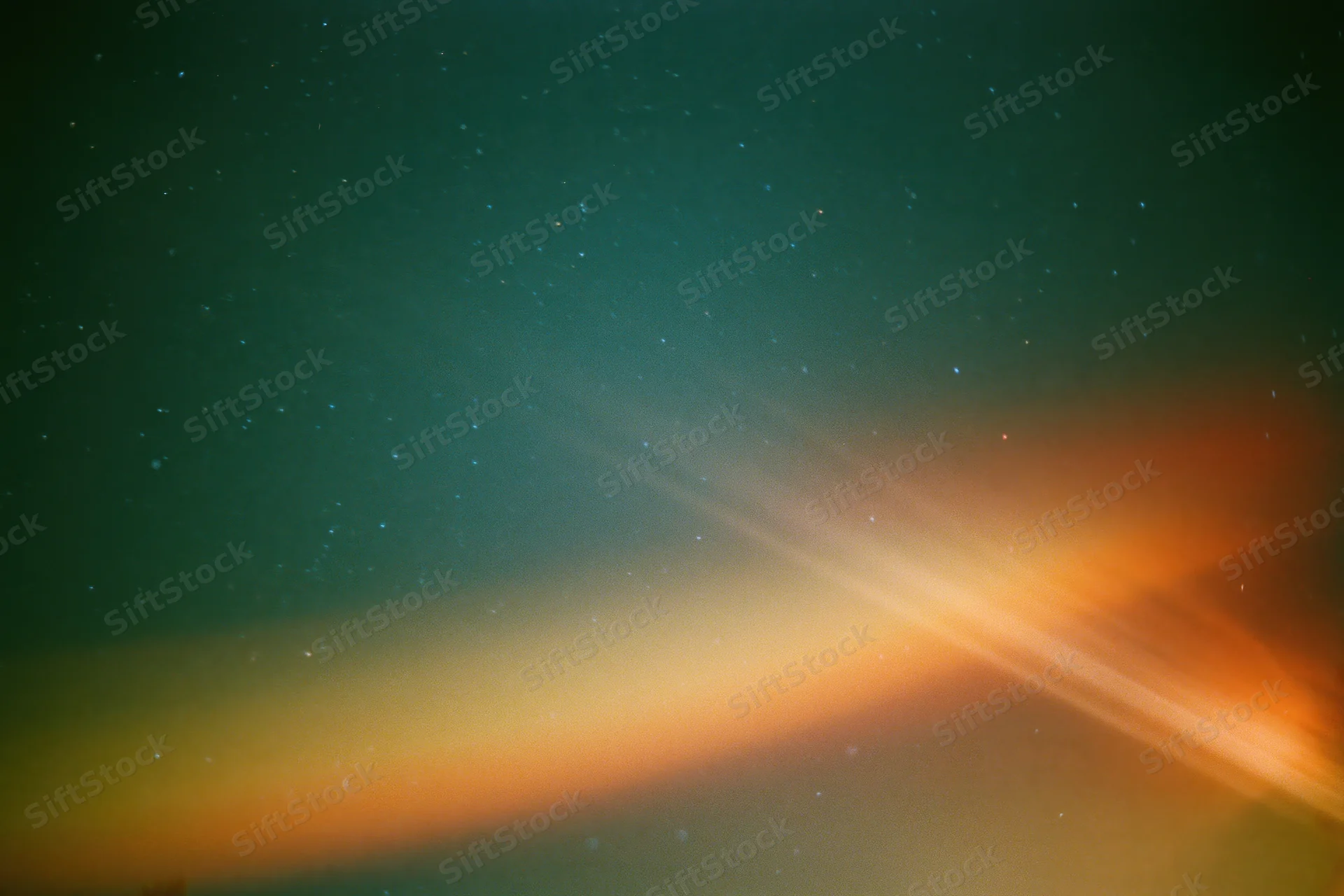 Lens flare and light leak across a dark night sky with scattered stars and color gradient