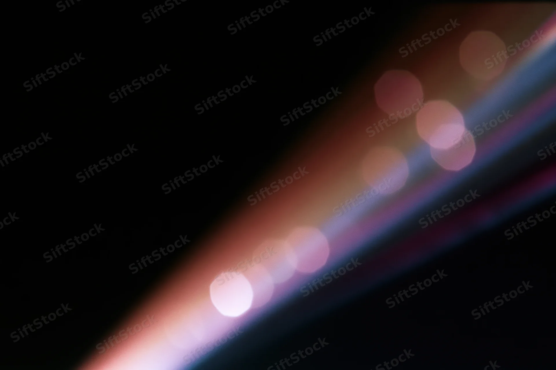 Lens flare and light leak overlay on black background with diagonal bokeh glow