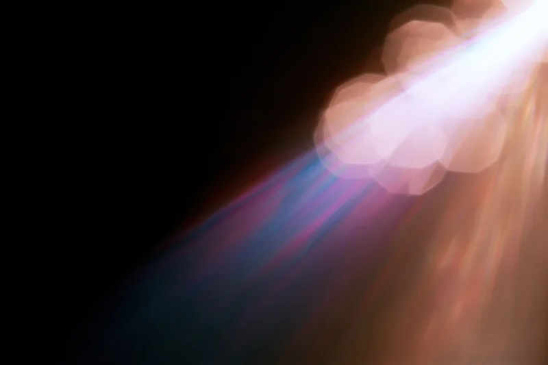 Lens flare and light leak effect on black background with colorful rays and bokeh highlights