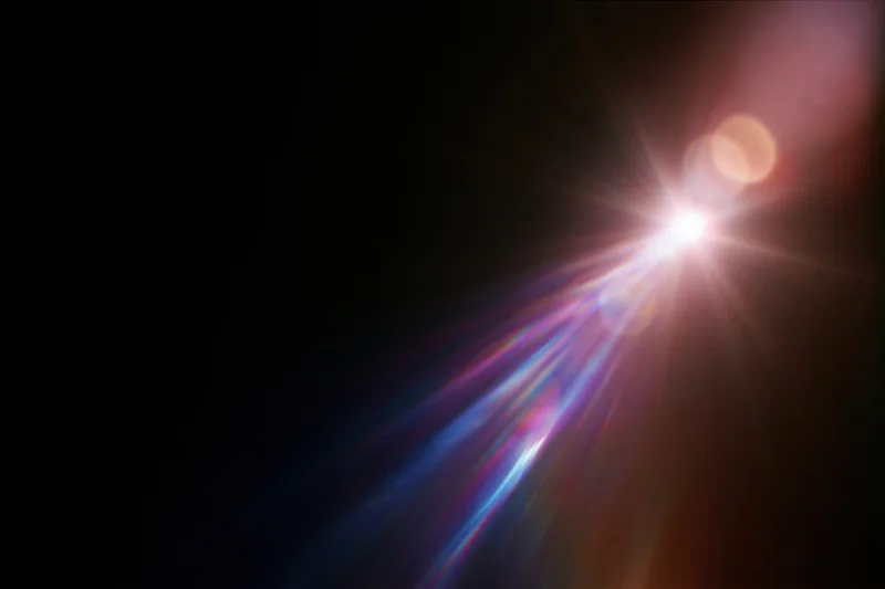 Lens flare and light leak effect on a black background with colorful rays and bokeh highlights