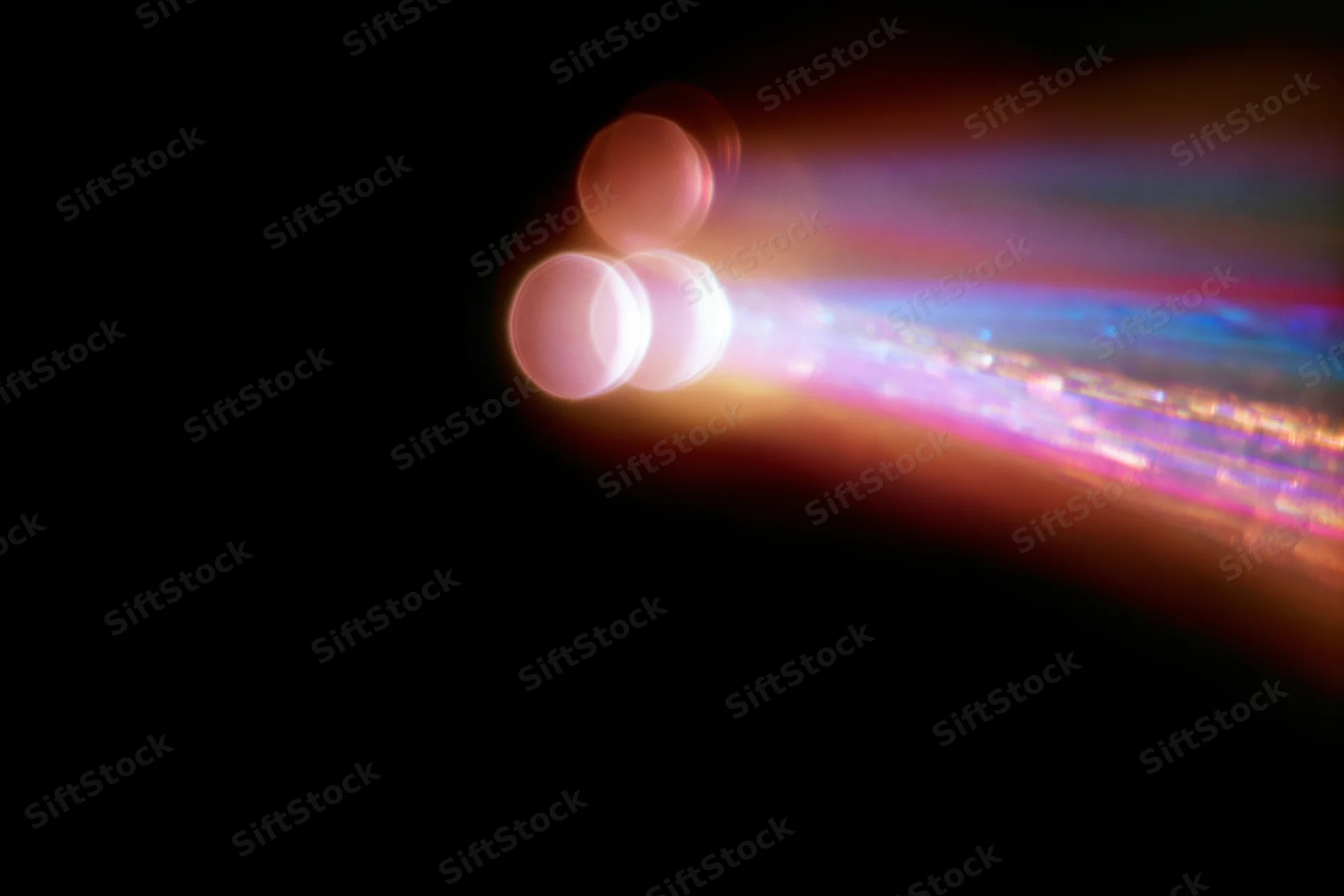 Lens flare and light leak effect on black background with colorful streaks and bokeh circles