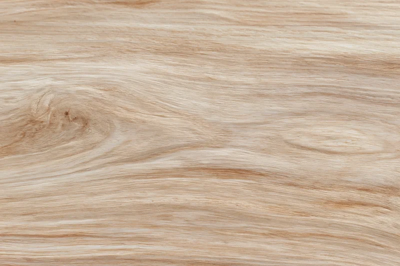 Light blonde wood surface filling the frame in flat lay top view