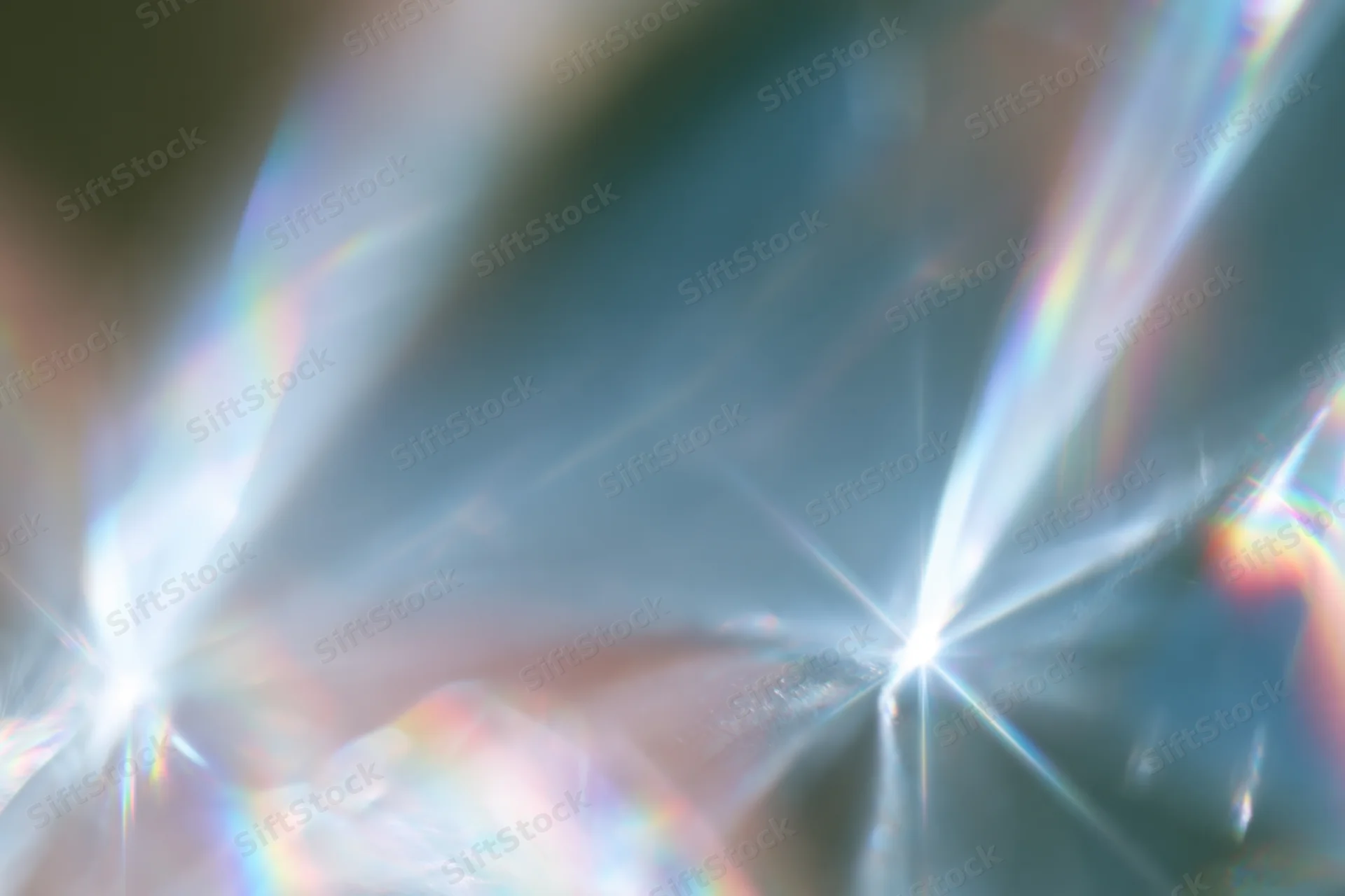 Light refracting through a crystal surface creating rainbow dispersion and starburst flares