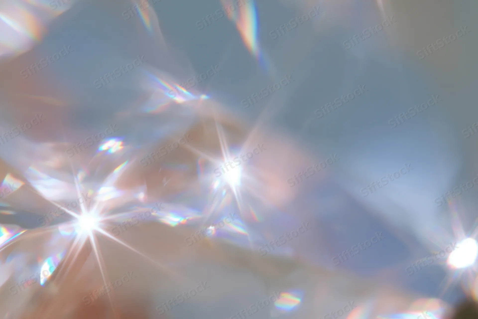Light refracting through a crystal surface creating starburst patterns and rainbow hues